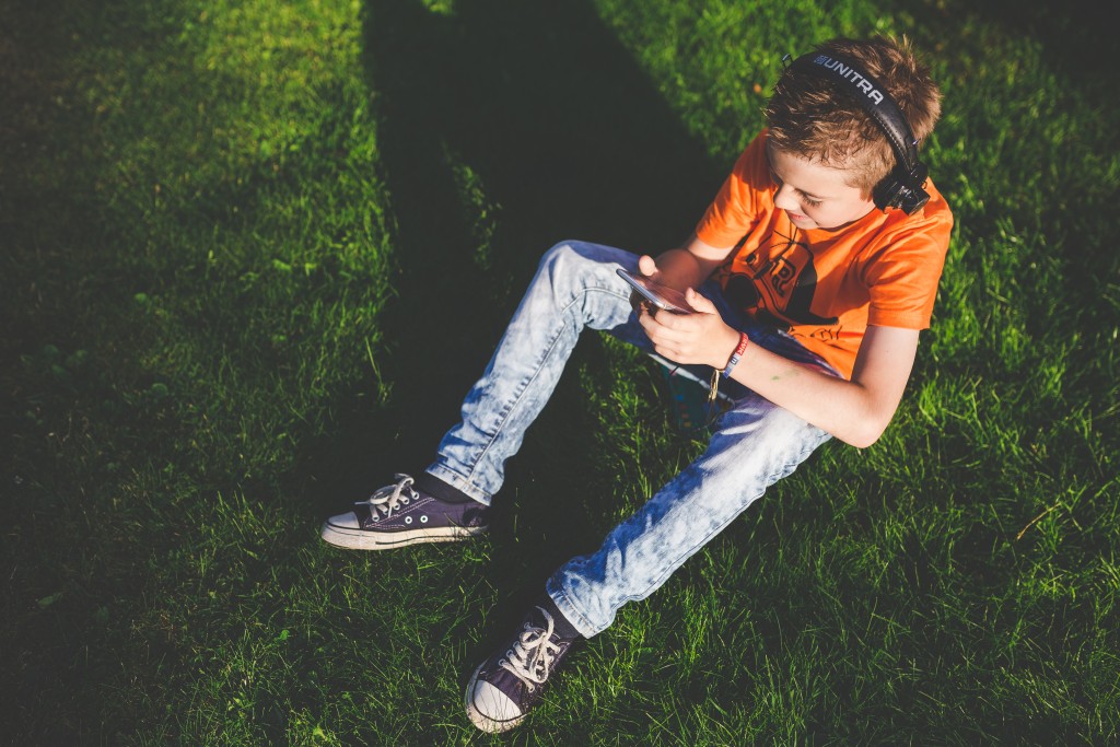 kaboompics.com_young_boy_listening_to_music_through_headphones_on_the_nature.jpg
